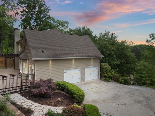 4515 N Slope Cir, Marietta, GA 30066 - view of home's exterior with fence, roof with shingles, a chimney, and concrete driveway