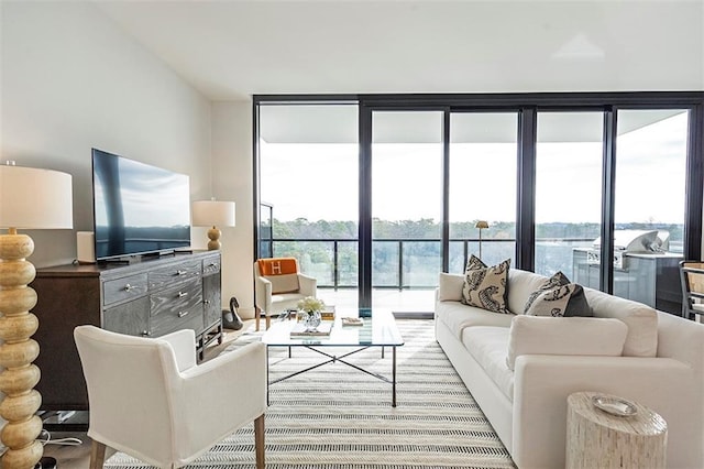 living room with a water view and a wall of windows