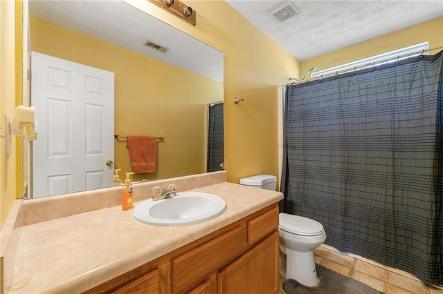 full bath with visible vents, a textured ceiling, toilet, and vanity