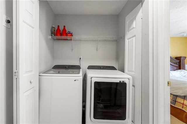 laundry area with laundry area and washing machine and clothes dryer