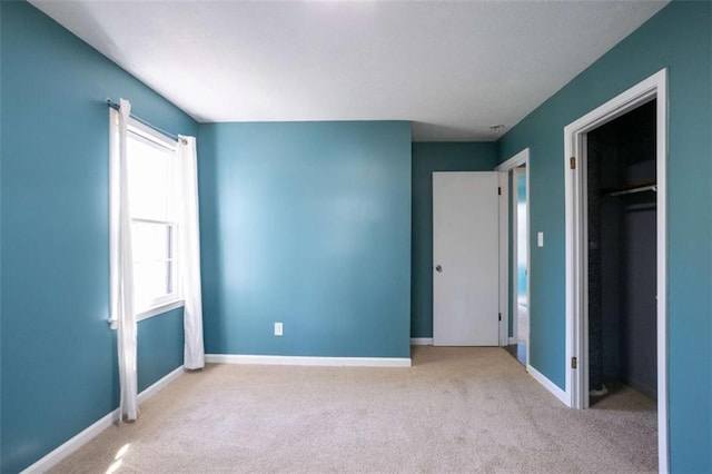 unfurnished bedroom with carpet floors and baseboards