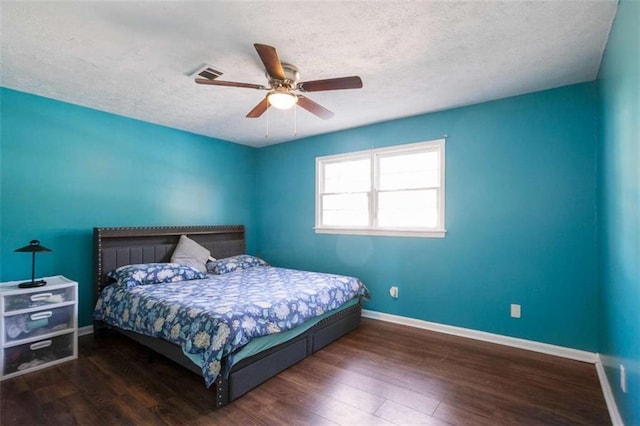 bedroom with visible vents, baseboards, and wood finished floors