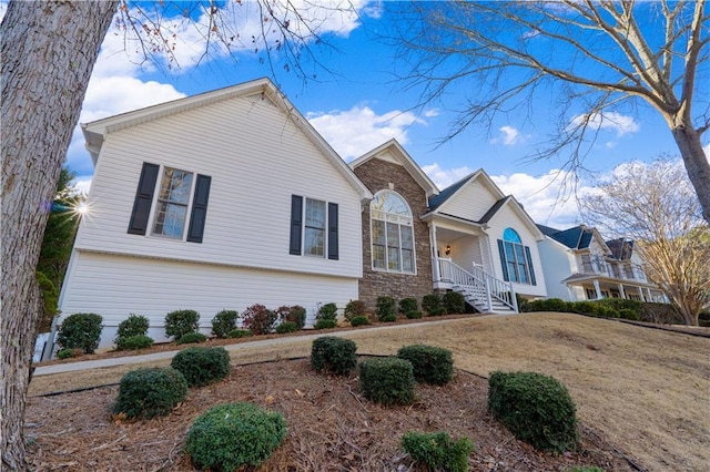 view of front of house featuring a front yard and stone siding