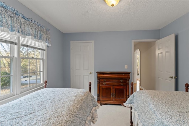 bedroom featuring arched walkways and a textured ceiling