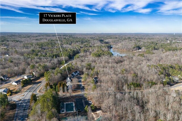 aerial view featuring a forest view and a water view