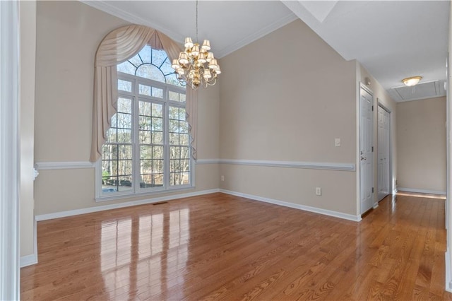 spare room featuring plenty of natural light, visible vents, baseboards, and wood finished floors