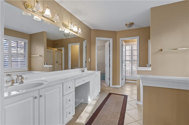 bathroom featuring a healthy amount of sunlight, a sink, and tile patterned floors