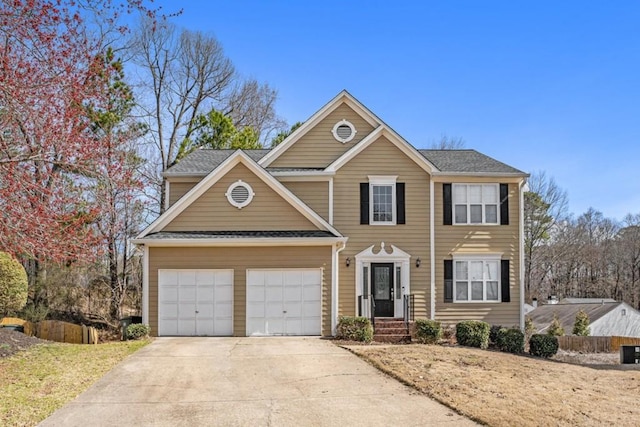 view of front of house with driveway, an attached garage, and central AC