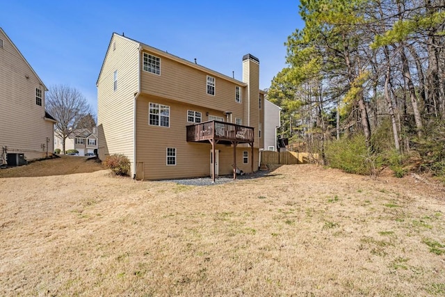 back of property featuring central AC, a deck, and a chimney