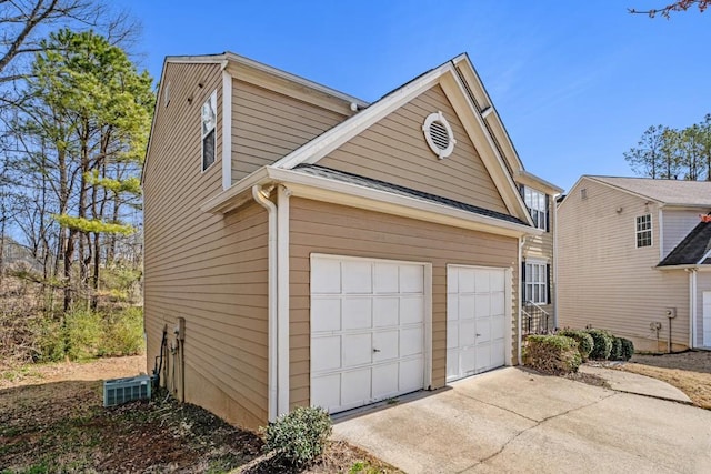 garage featuring concrete driveway