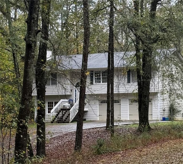 back of property with a garage