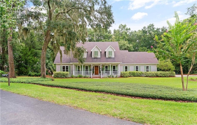 cape cod-style house with a porch and a front lawn