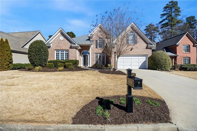 traditional home featuring a garage, brick siding, driveway, and a front lawn