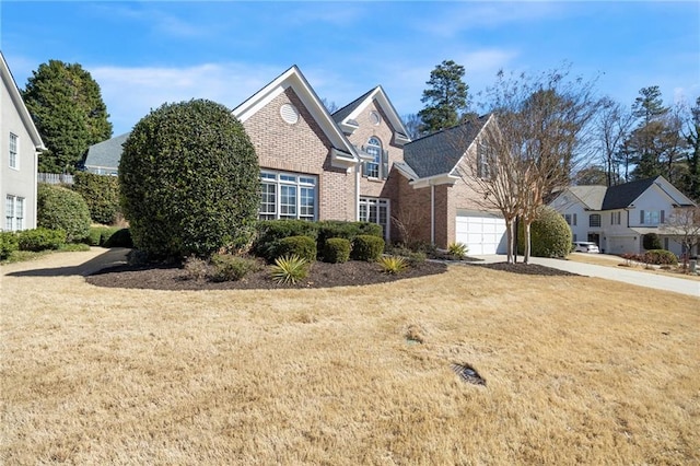 traditional home featuring a front yard, brick siding, and driveway