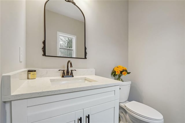bathroom with toilet and vanity