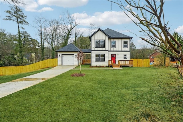 tudor-style house featuring fence, board and batten siding, an outdoor structure, driveway, and a detached garage