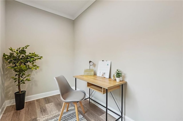 office space featuring baseboards and wood finished floors