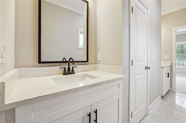 bathroom featuring vanity, baseboards, and marble finish floor