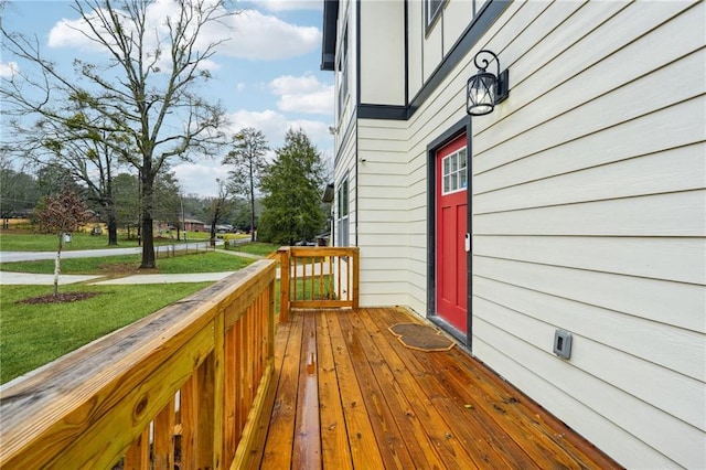 wooden deck with a lawn