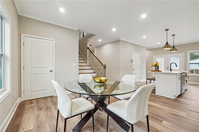 dining room featuring french doors, light wood-style flooring, recessed lighting, baseboards, and stairs