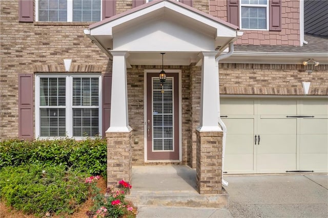 2677 Sardis Chase Ct, Buford, GA 30519 - view of exterior entry featuring driveway, a shingled roof, covered porch, and brick siding