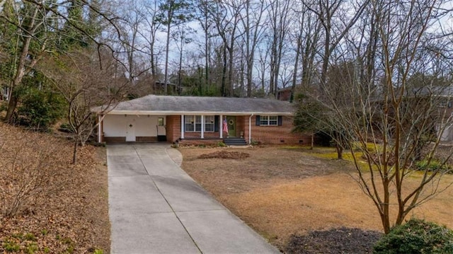 single story home with crawl space, a carport, concrete driveway, and brick siding