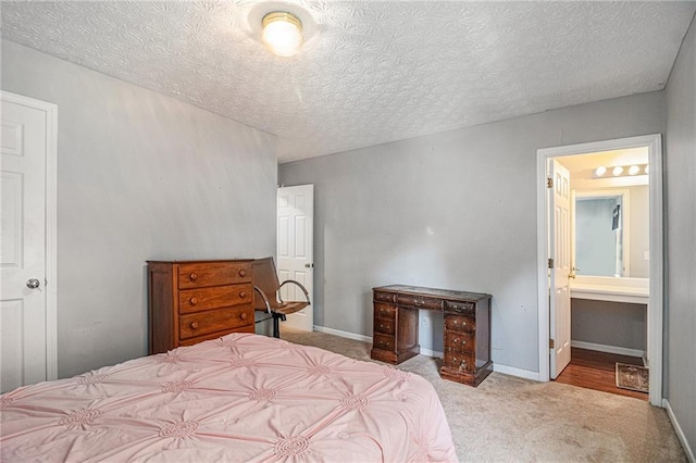 121 Ashgate Way, Carrollton, GA 30117 - bedroom with carpet flooring, a textured ceiling, baseboards, and connected bathroom