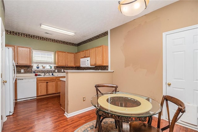 121 Ashgate Way, Carrollton, GA 30117 - kitchen featuring white appliances, dark wood-style floors, a textured ceiling, backsplash, and a sink