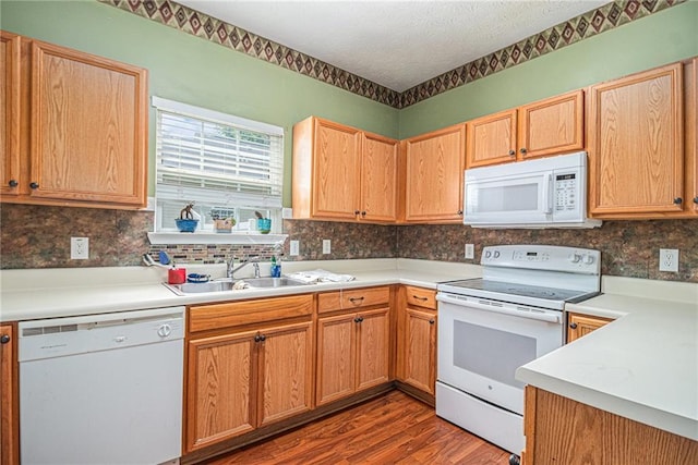 121 Ashgate Way, Carrollton, GA 30117 - kitchen with white appliances, a sink, wood finished floors, backsplash, and light countertops