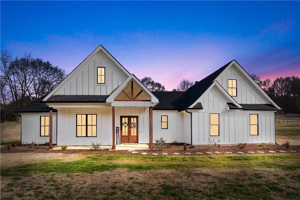 modern farmhouse featuring a yard