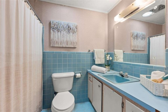 bathroom featuring wainscoting, toilet, ornamental molding, and vanity