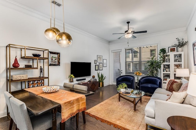 living area with visible vents, baseboards, a ceiling fan, ornamental molding, and dark wood-style flooring