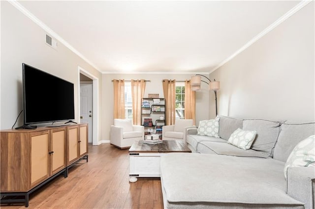 living room with hardwood / wood-style flooring and crown molding