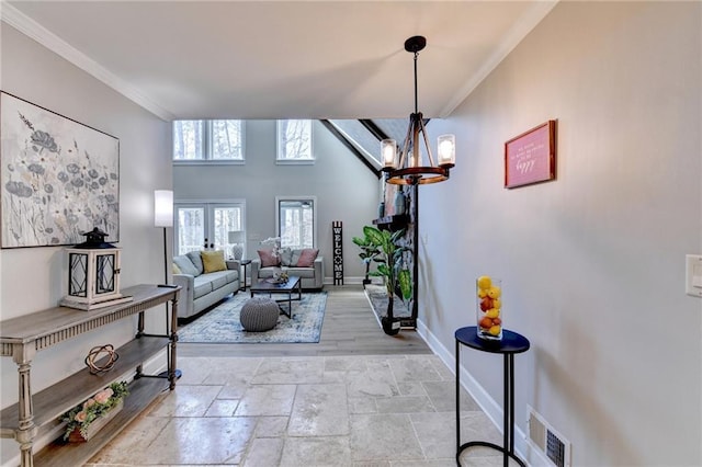 living room featuring baseboards, french doors, visible vents, and crown molding