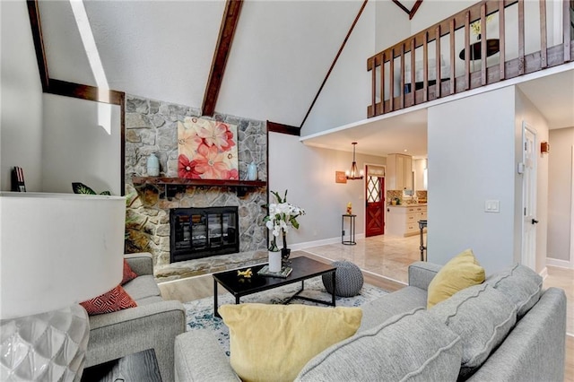 living area featuring baseboards, wood finished floors, a fireplace, high vaulted ceiling, and beam ceiling