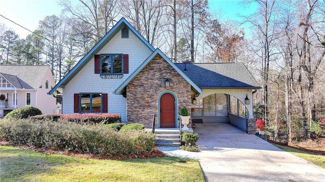 view of front facade featuring stone siding, concrete driveway, and roof with shingles