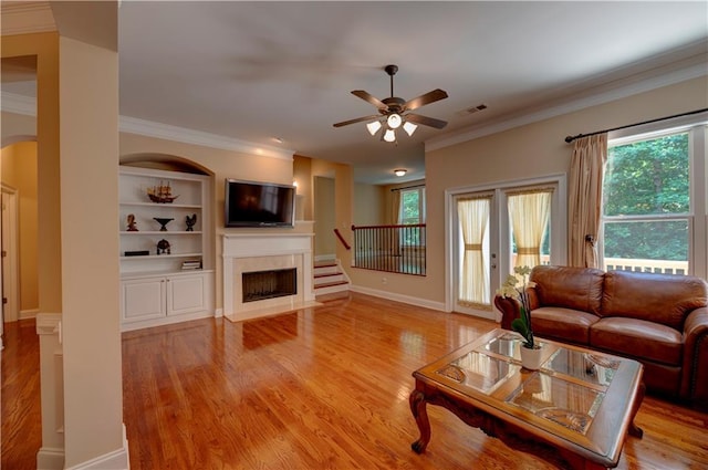 1622 Rivergreen Bnd SE Unit 26, Atlanta, GA 30339 - living area with a ceiling fan, ornamental molding, a fireplace, light wood-type flooring, and stairway