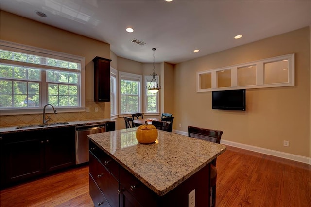 1622 Rivergreen Bnd SE Unit 26, Atlanta, GA 30339 - kitchen with stainless steel dishwasher, light wood-style flooring, light stone countertops, a kitchen island, and backsplash
