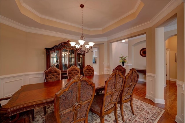1622 Rivergreen Bnd SE Unit 26, Atlanta, GA 30339 - dining room featuring arched walkways, a chandelier, a raised ceiling, wood finished floors, and crown molding