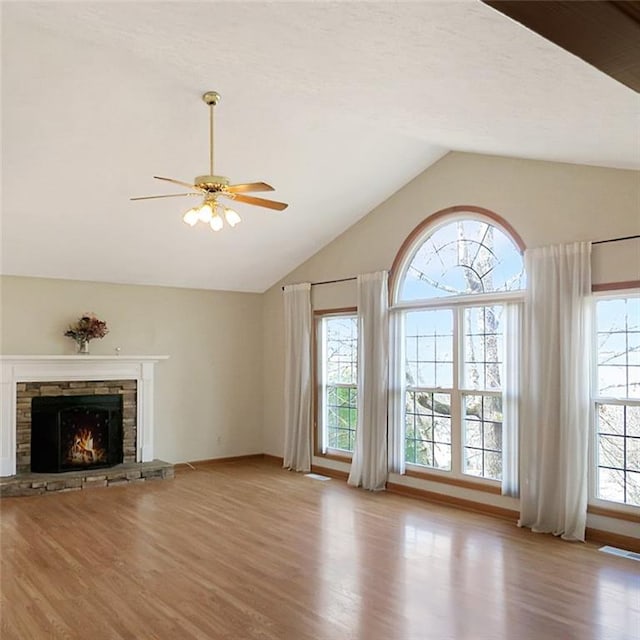 unfurnished living room featuring visible vents, a ceiling fan, lofted ceiling, wood finished floors, and a fireplace