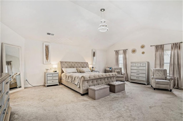 carpeted bedroom with vaulted ceiling