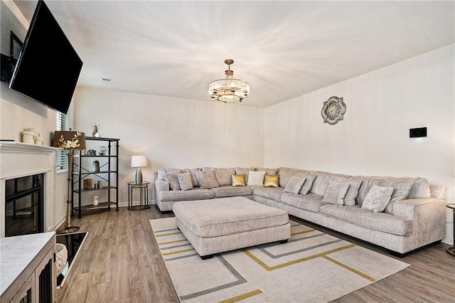 living room with wood-type flooring and an inviting chandelier