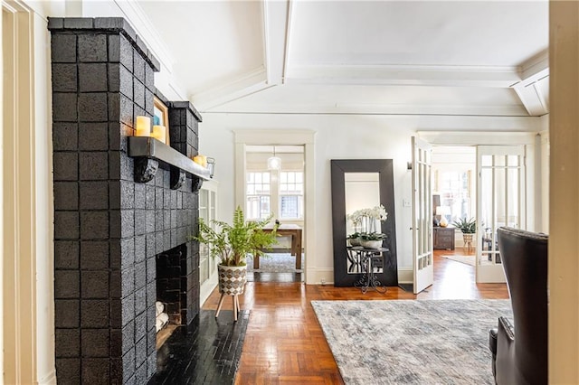 interior space featuring french doors, parquet floors, lofted ceiling with beams, and a brick fireplace