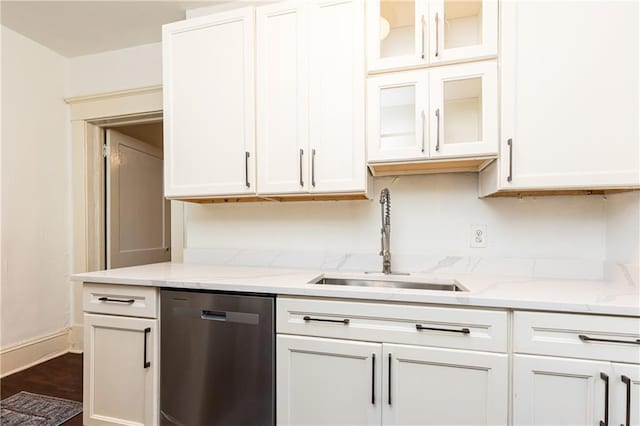 kitchen with light stone counters, sink, dishwasher, dark hardwood / wood-style floors, and white cabinetry