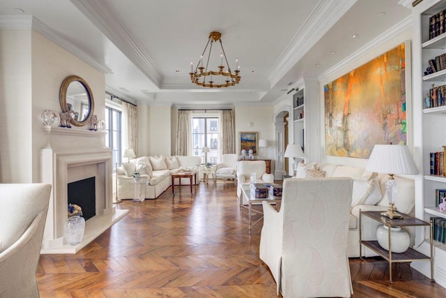 living room featuring dark parquet flooring, ornamental molding, built in features, and a notable chandelier