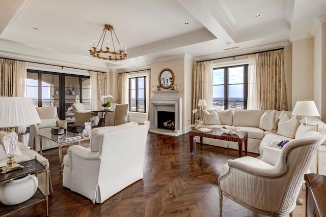 living room featuring dark parquet flooring, a chandelier, a wealth of natural light, and crown molding