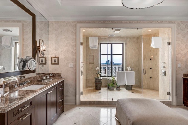 bathroom featuring a shower with door, vanity, and ornamental molding