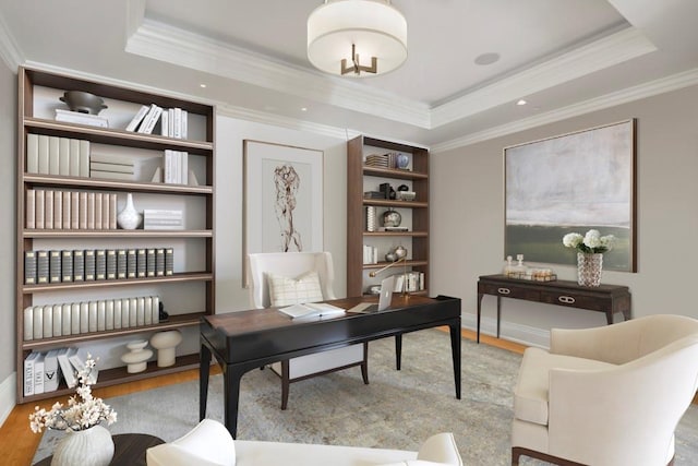 home office featuring light hardwood / wood-style floors, crown molding, and a raised ceiling