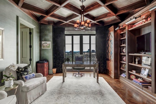 office space featuring coffered ceiling, a chandelier, built in shelves, and beamed ceiling