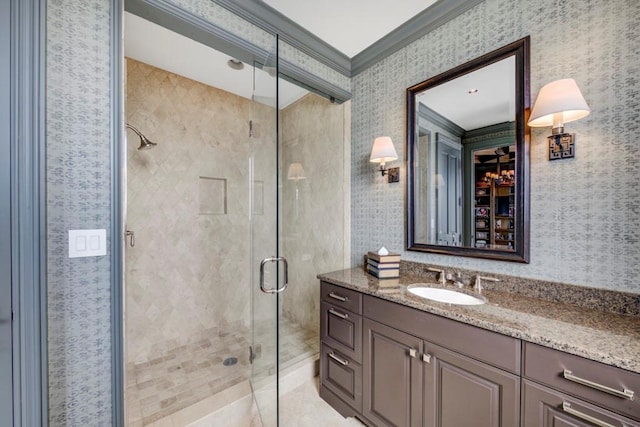 bathroom with an enclosed shower, vanity, tile patterned floors, and ornamental molding